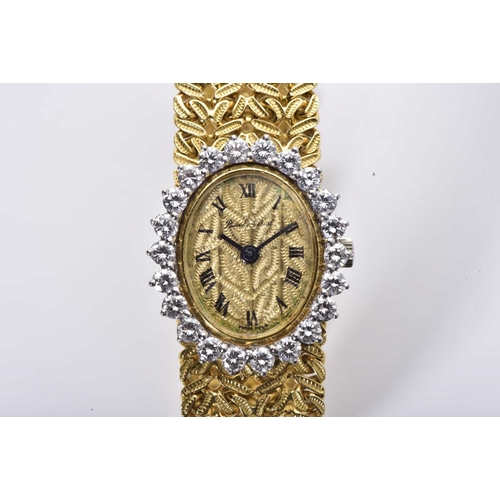 414 - A LADY'S DIAMOND AND GOLD WRISTWATCH, BUECHE GIROD