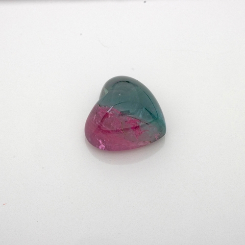 452 - AN UNMOUNTED HEART-SHAPED CABOCHON BI-COLOUR TOURMALINE