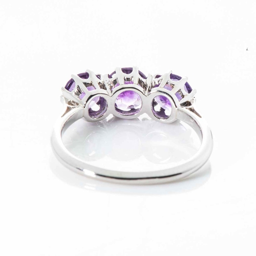 566 - AN AMETHYST TRILOGY RING