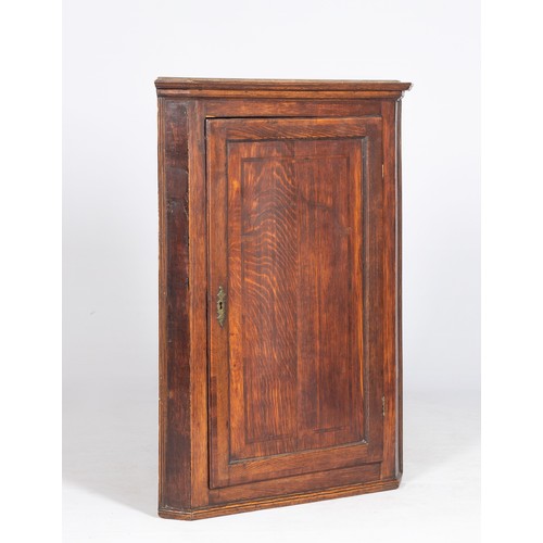 120 - A GEORGE III OAK HANGING CORNER CUPBOARD