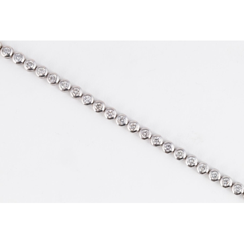 552 - A DIAMOND TENNIS BRACELET