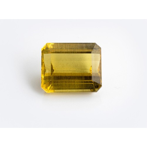 557 - AN UNMOUNTED CUT-CORNERED RECTANGULAR STEP-CUT GOLDEN APATITE