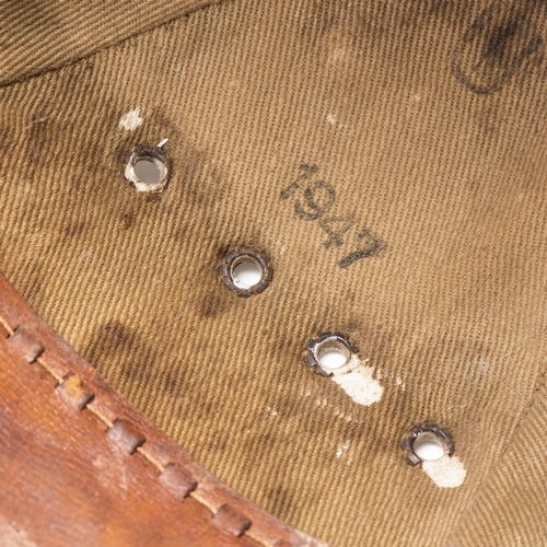 385 - A PITH HELMET, DATED 1947