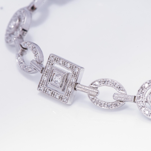 932 - A BROWNS DIAMOND TENNIS BRACELET, CIRCA 1990S