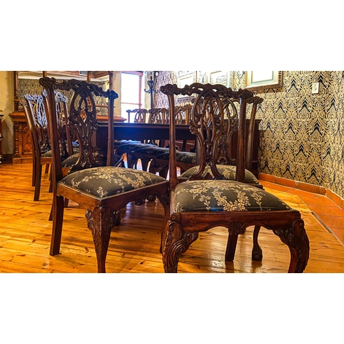 251 - A SET OF TWELVE GEORGE III STYLE CHAIRS Each pierced scrolling top rail above a pierced urn- shaped ... 