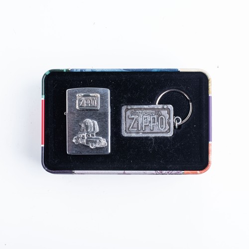 133 - A CASED BRADFORD ZIPPO LIGHTER AND KEYRING