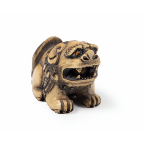 617 - A JAPANESE IVORY NETSUKE OF A SHI-SHI, MEIJI PERIOD, 1868 - 1912