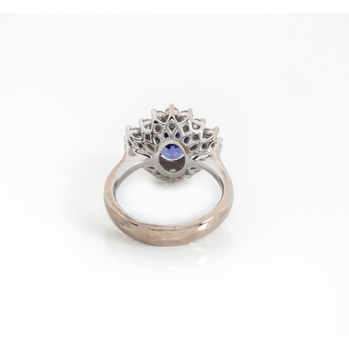 928 - A TANZANITE AND DIAMOND RING, BROWNS