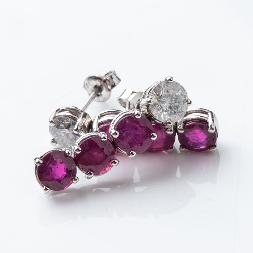 843 - A PAIR OF RUBY AND DIAMOND EARRINGS Claw-set with 6 round brilliant-cut rubies with a combined weigh... 