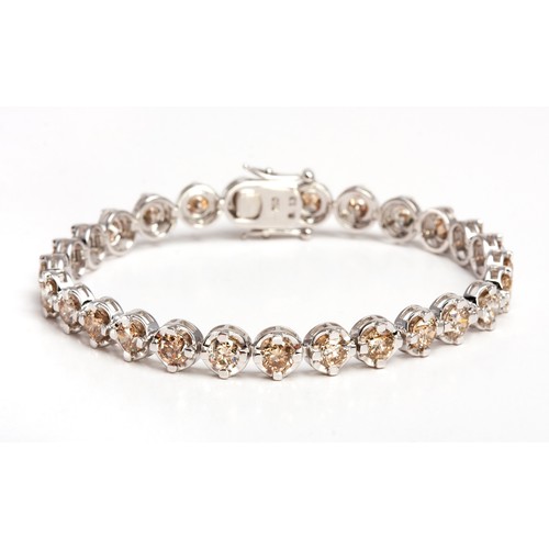 403 - A DIAMOND TENNIS BRACELET