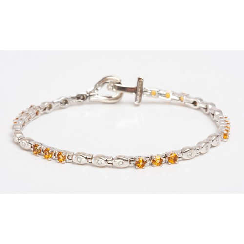 384 - A DIAMOND AND CITRINE TENNIS BRACELET