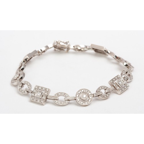 390 - A DIAMOND TENNIS BRACELET, BROWNS