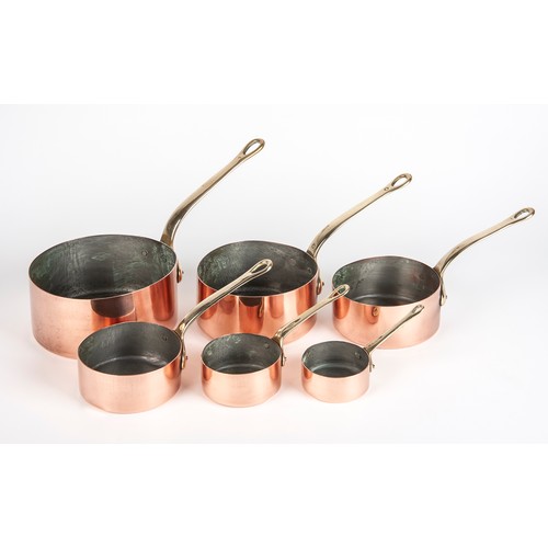 208 - A SET OF SIX TIN-LINED COPPER SAUCEPANS WITH BRASS HANDLES