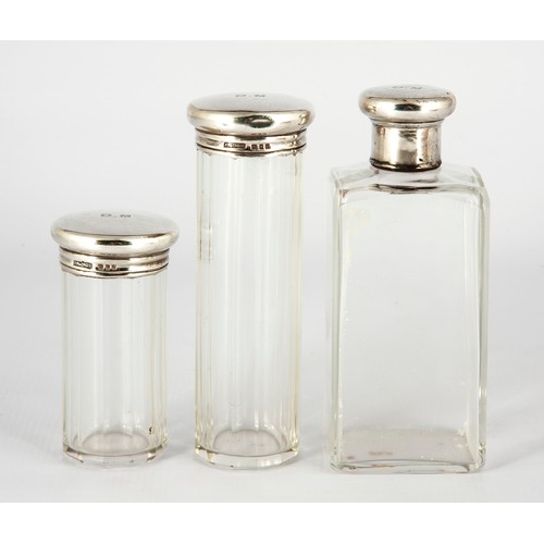 149 - GROUP OF THREE SILVER-TOPPED GLASS DRESSING TABLE BOTTLES