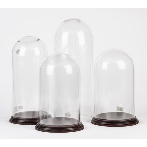 58 - A GROUP OF FOUR GLASS DOMES