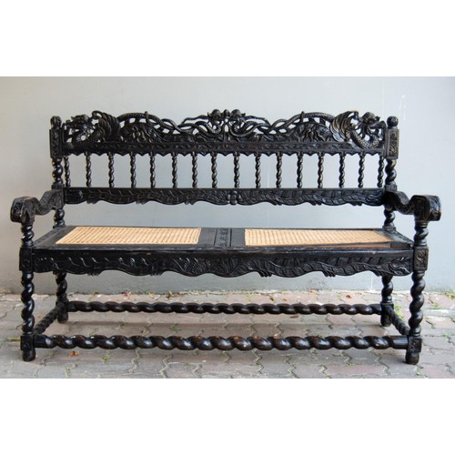 186 - AN ANGLO-INDIAN STYLE EBONISED BENCH