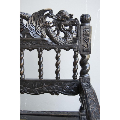 186 - AN ANGLO-INDIAN STYLE EBONISED BENCH