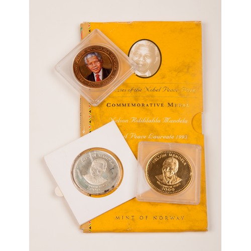 57 - A COLLECTION OF NELSON MANDELA COINS AND MEDALLIONS