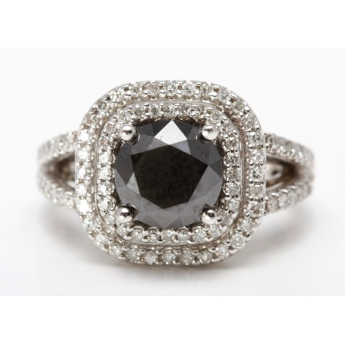 148 - A BLACK AND WHITE DIAMOND DRESS RING