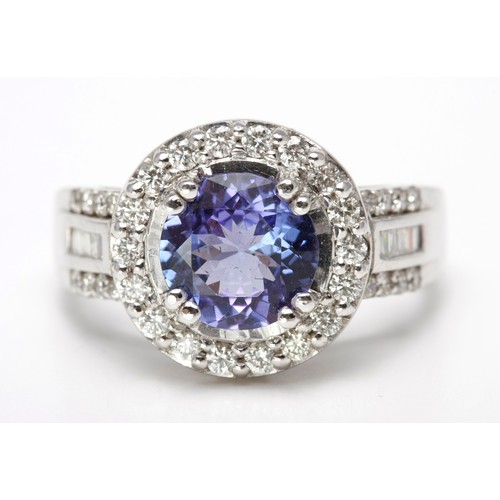 185 - A TANZANITE AND DIAMOND DRESS RING