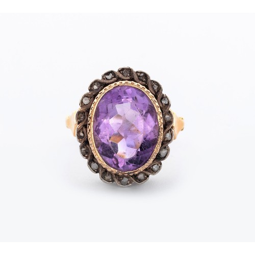 497 - AN AMETHYST AND DIAMOND RING