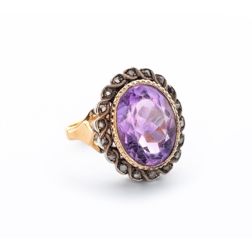 497 - AN AMETHYST AND DIAMOND RING