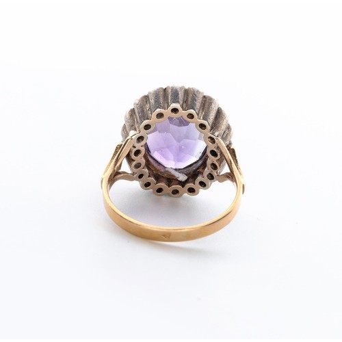 497 - AN AMETHYST AND DIAMOND RING