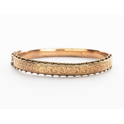 499 - A 9CT GOLD HINGED BANGLE