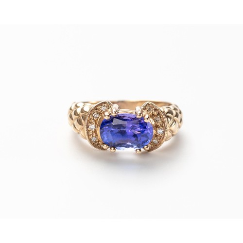 564 - A TANZANITE AND DIAMOND RING