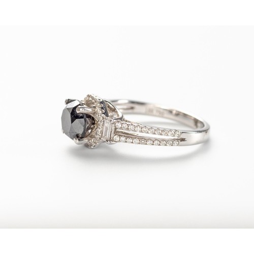 565 - A BLACK AND WHITE DIAMOND RING