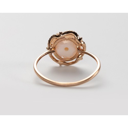 573 - A CARVED SHELL AND DIAMOND RING