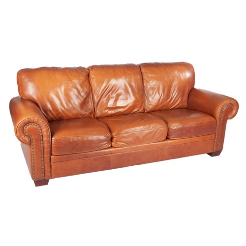 776 - A TAN LEATHER THREE SEATER SOFA