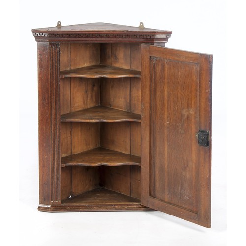 524 - A GEORGE III OAK HANGING CORNER CABINET