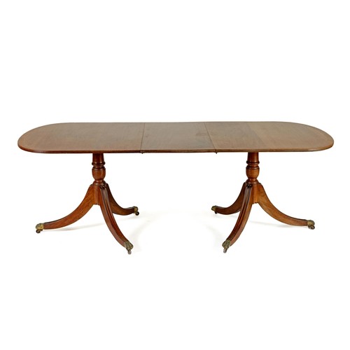 221 - A REGENCY STYLE MAHOGANY EXTENDING DINING TABLE