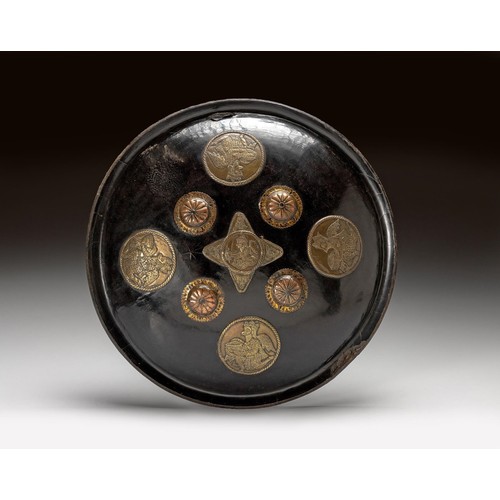 1084 - AN INDIAN BLACK LACQUERED LEATHER DAHL SHIELD, 19TH CENTURY