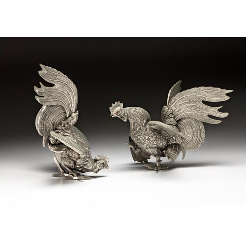 1064 - A PAIR OF WHITE METAL FIGHTING COCKERELS