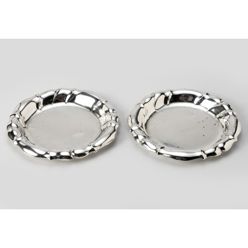 1003 - A PAIR OF CONTINENTAL SILVER-PLATE WINE BOTTLE COASTERS