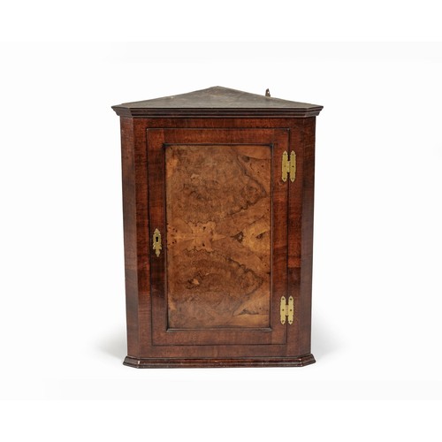 196 - A GEORGE III WALNUT HANGING CORNER CUPBOARD