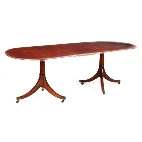 26 - A MAHOGANY TWIN PILLAR EXTENDING TABLE