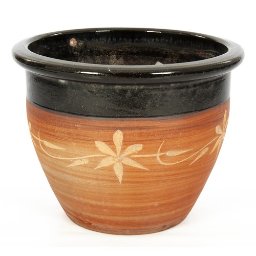 557 - A PARTIALLY GLAZED TERRACOTTA PLANTER