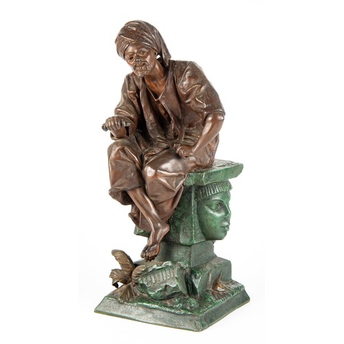 604 - A SPELTER ORIENTALIST FIGURE OF A SEATED MAN