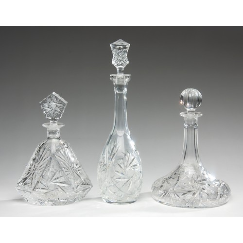 587 - THREE ASSORTED CUT-GLASS DECANTERS