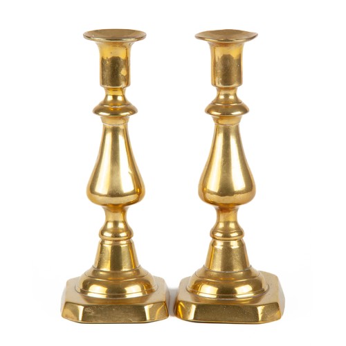 610 - A PAIR OF BRASS CANDLESTICKS