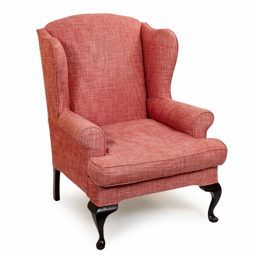 30 - AN UPHOLSTERED WINGBACK ARMCHAIR