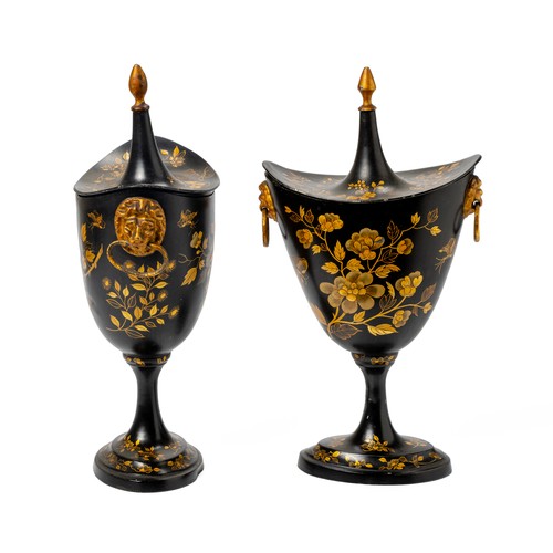 153 - A PAIR OF SHAPED BLACK METAL PEDESTAL URNS AND COVERS