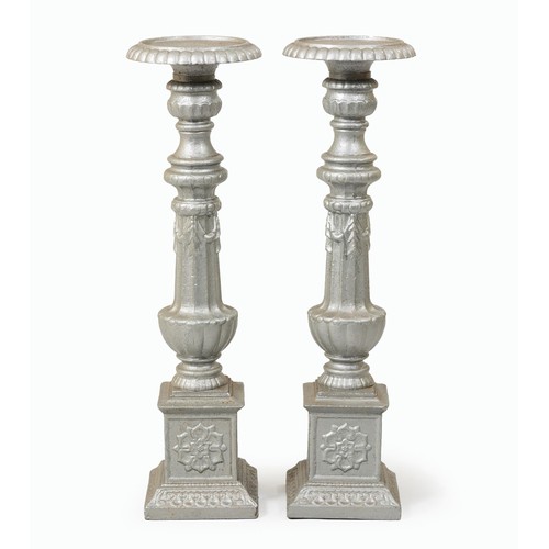 200 - A PAIR OF TALL CAST IRON CANDLESTICKS