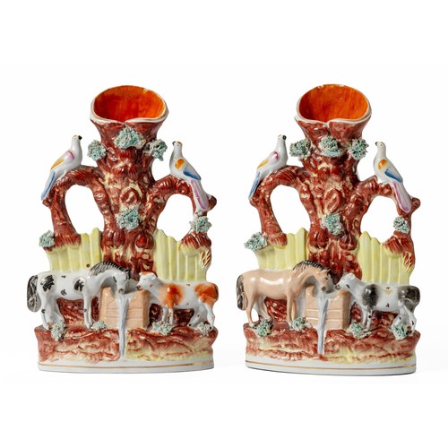 277 - A PAIR OF VICTORIAN STAFFORDSHIRE FLATBACK SPILL VASES DEPICTING A HORSE AND COW DRINKING AT A FOUNT... 