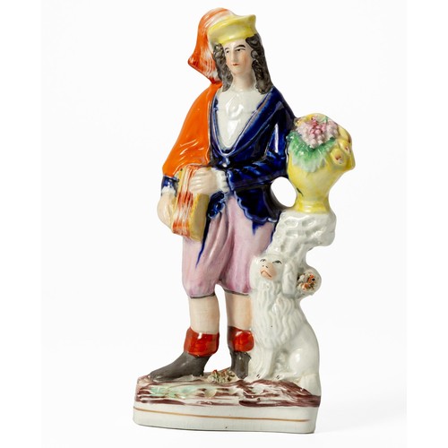 280 - A STAFFORDSHIRE FLATBACK FIGURE OF A MUSICIAN AND HIS DOG