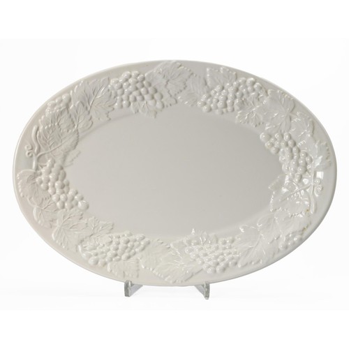 349 - A WHITE OVAL PLATTER WITH EMBOSSED VINE MOTIF