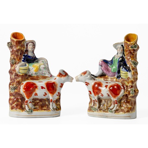 416 - A PAIR OF VICTORIAN STAFFORDSHIRE SPILLVASES OF A MILKMAID AND MILKMAN